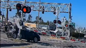 Train hits the car after the driver ignored the close gates